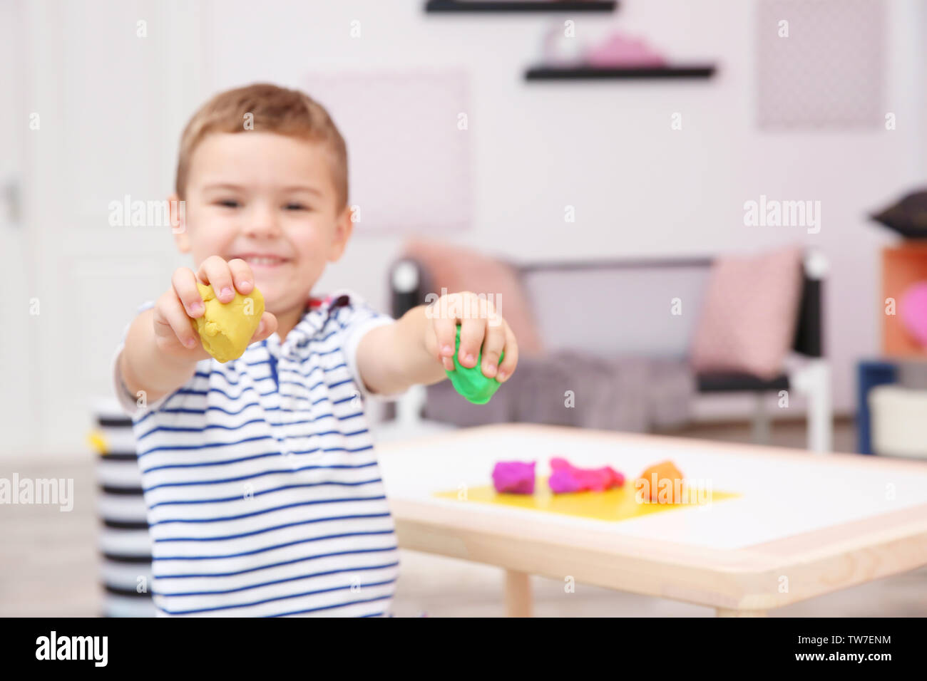 Cute little boy modeling from playdough at home Stock Photo - Alamy