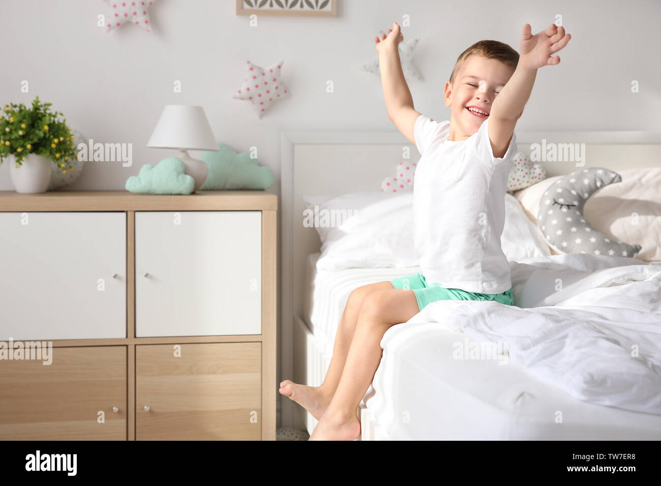 Cute little boy on bed at home Stock Photo - Alamy