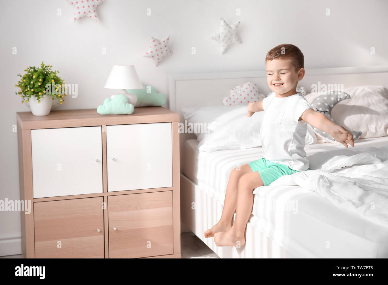 Cute little boy on bed at home Stock Photo - Alamy