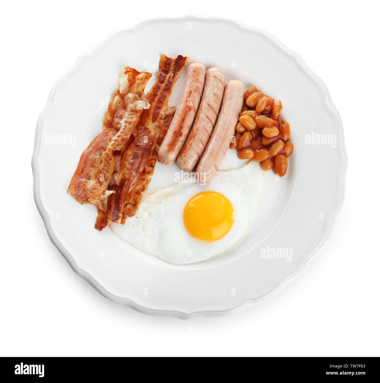 Plate with fried egg, sausages, bacon and beans on white background ...