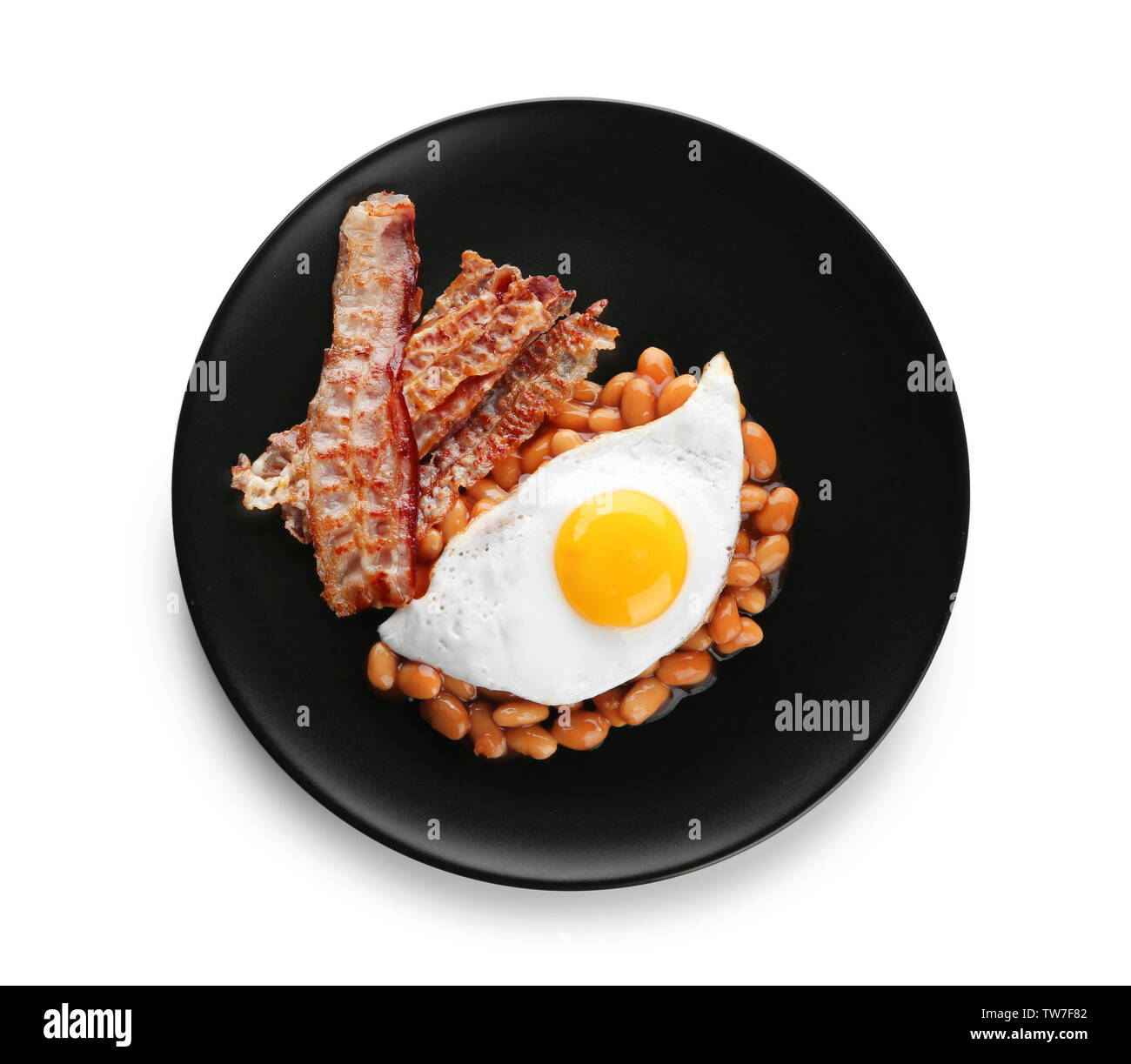 Plate with fried egg, bacon and beans on white background Stock Photo ...