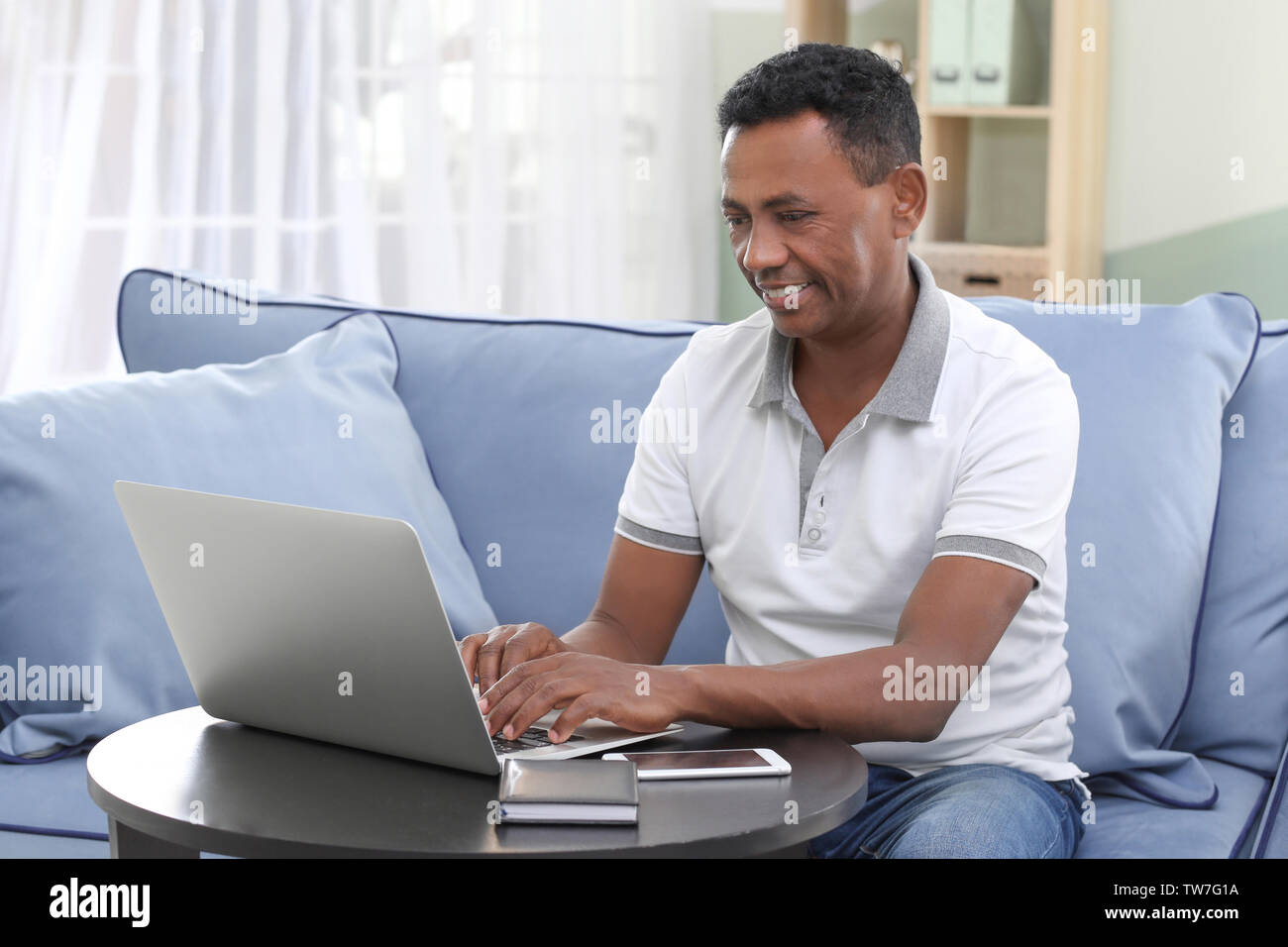 Mature adult home laptop indian hi-res stock photography and images - Alamy