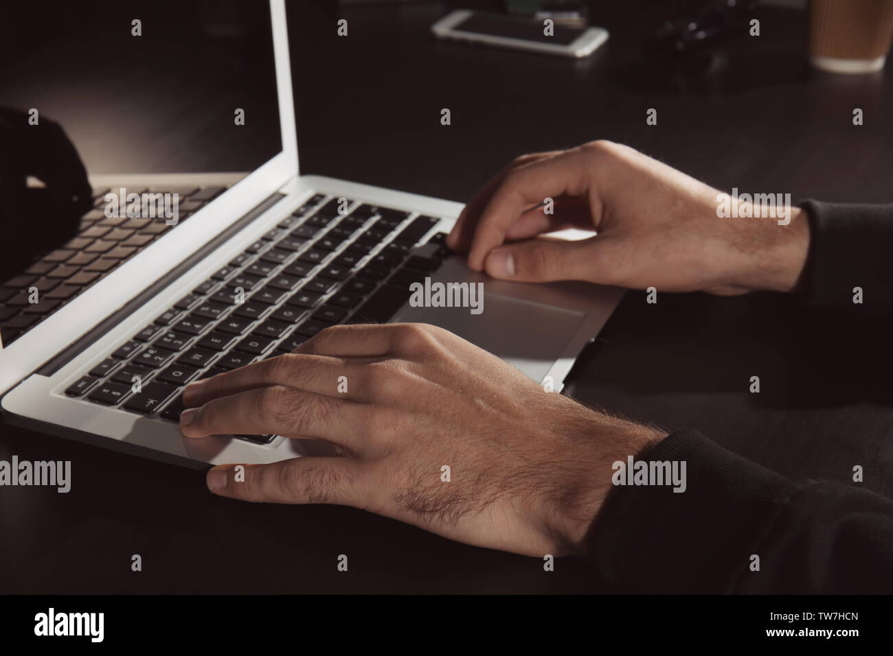 Man hacking server in dark room Stock Photo
