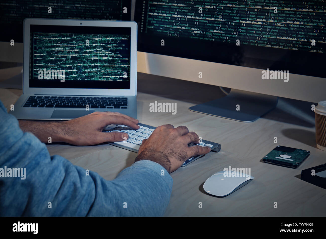 Man hacking server in dark room Stock Photo