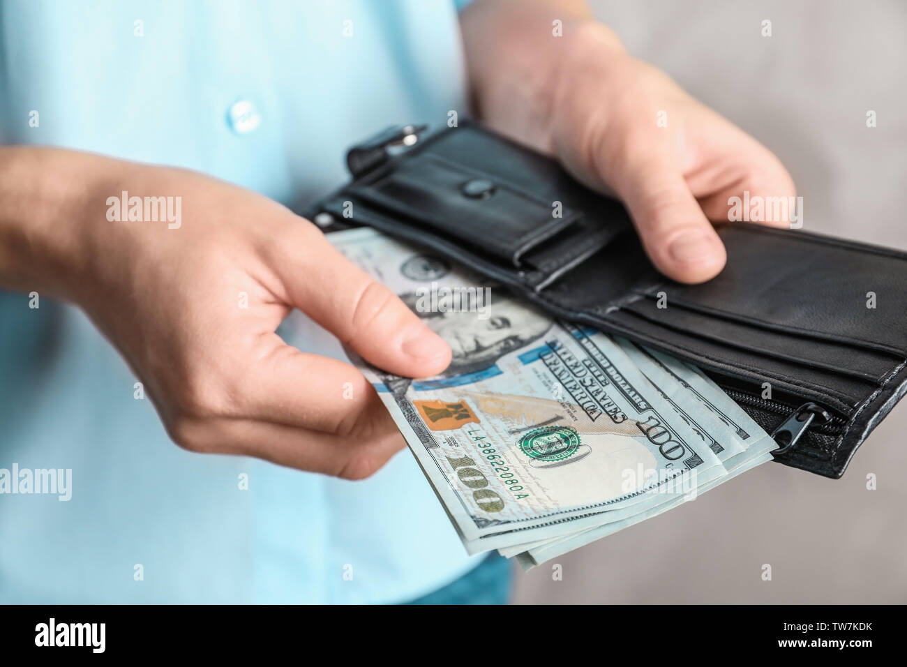 Woman holding wallet with dollar bills Stock Photo