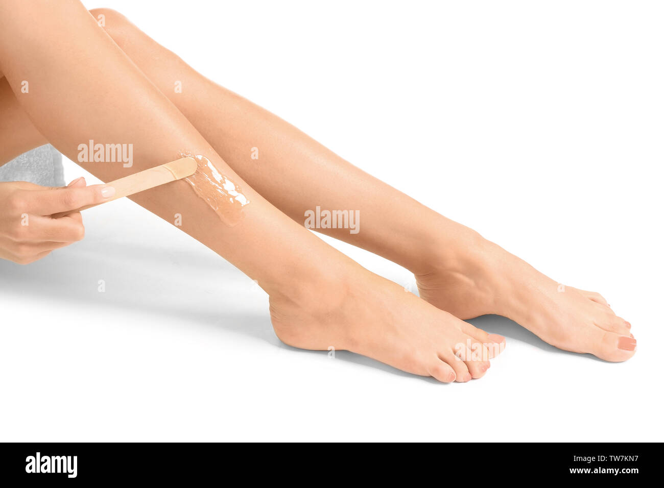 Beautiful woman epilating her legs, isolated on white Stock Photo Alamy