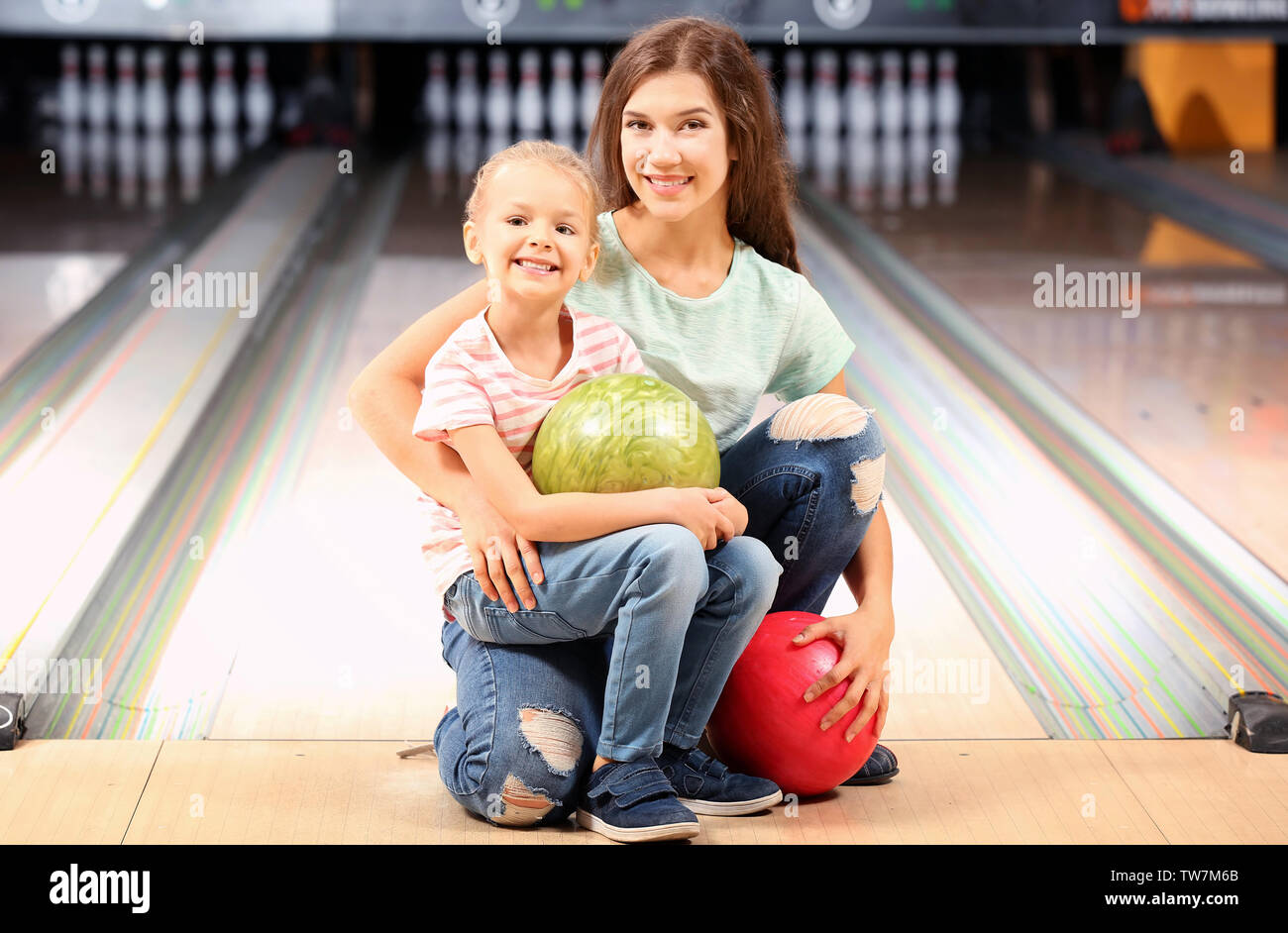Young mother with her daughter at bowling club Stock Photo Alamy