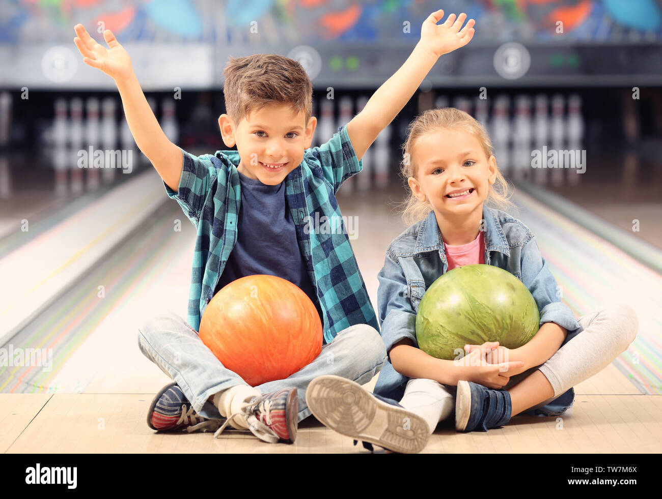 Cute little children at bowling club Stock Photo Alamy
