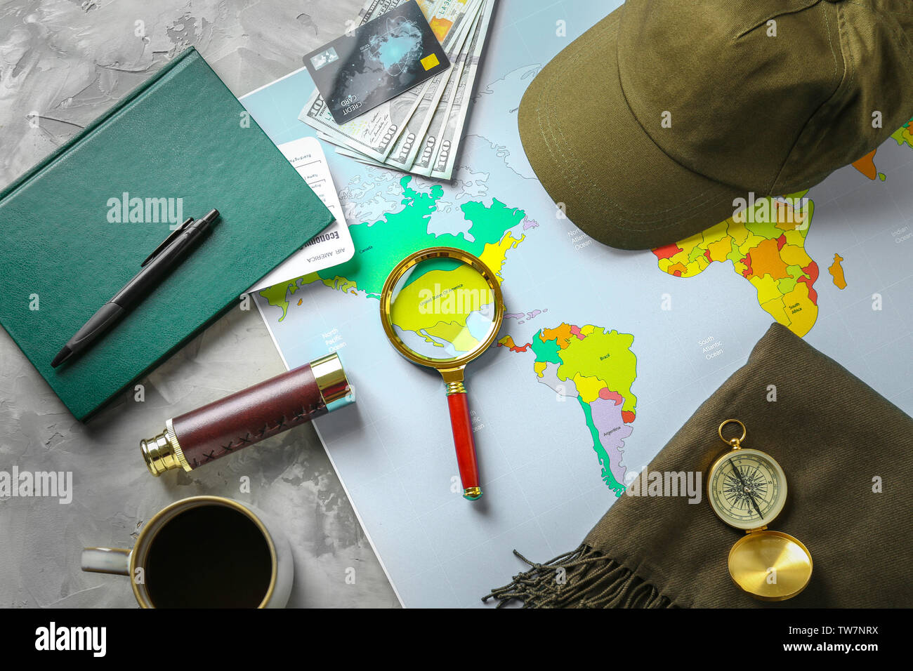 Composition with magnifying glass and world map on table Stock Photo
