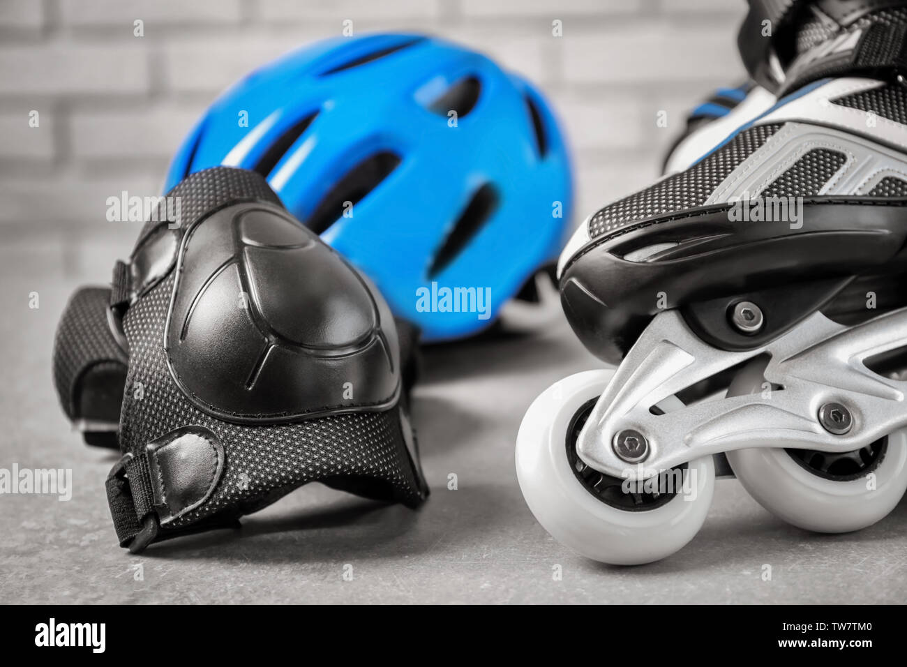 Roller skate and knee pad on floor, closeup Stock Photo - Alamy