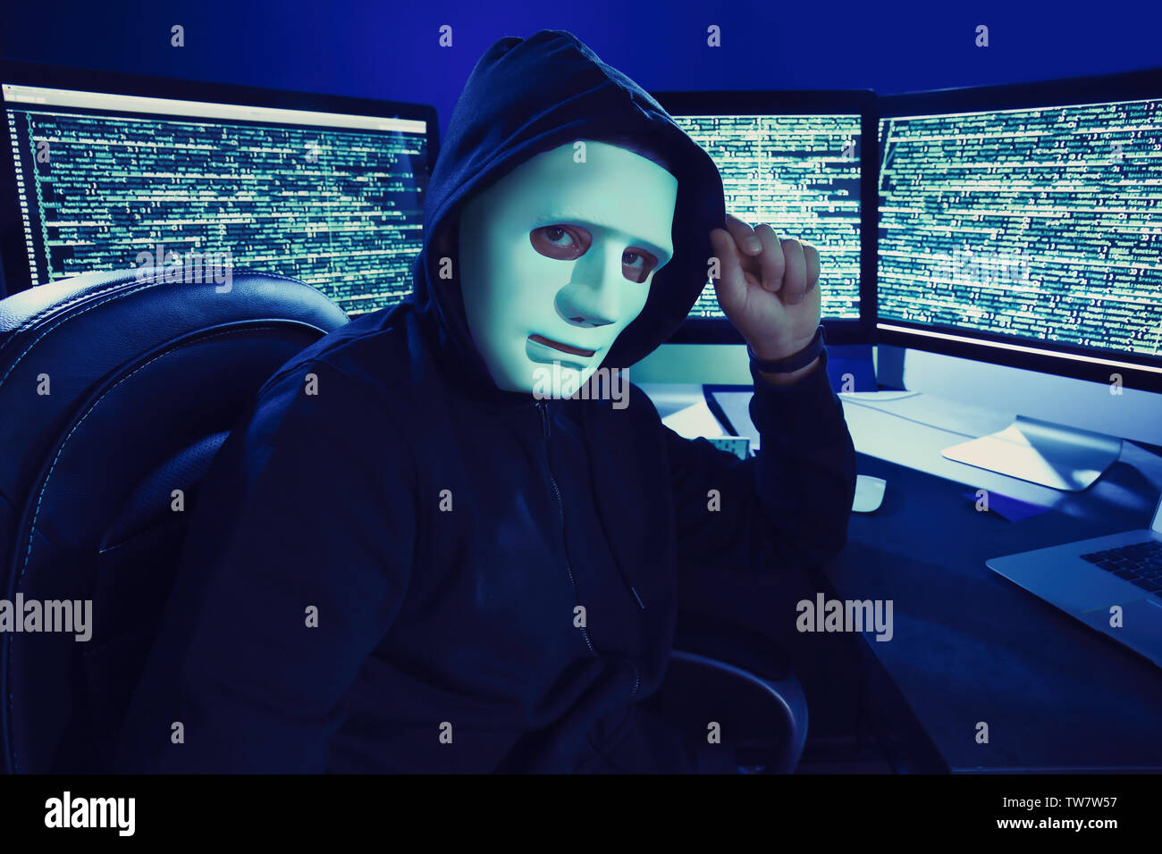 Hacker in mask sitting hi-res stock photography and images - Alamy