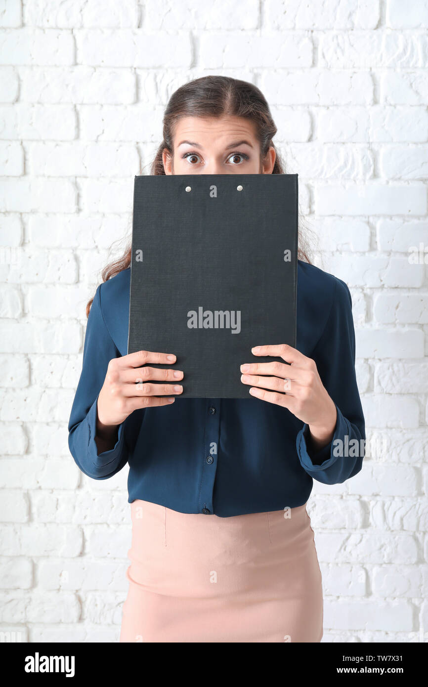 Young manager on brick wall background Stock Photo