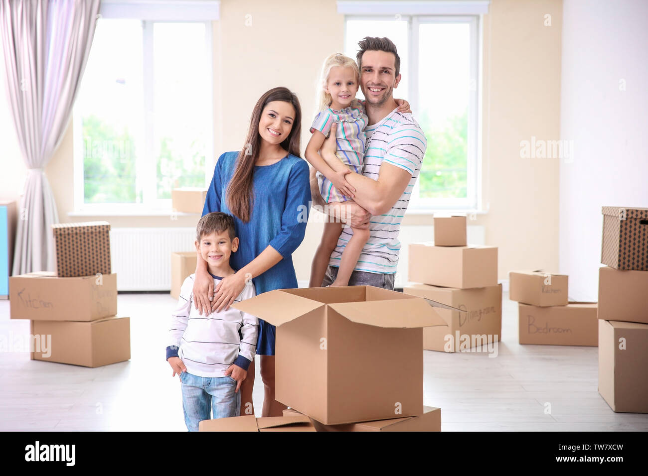 Happy family in their new home Stock Photo - Alamy