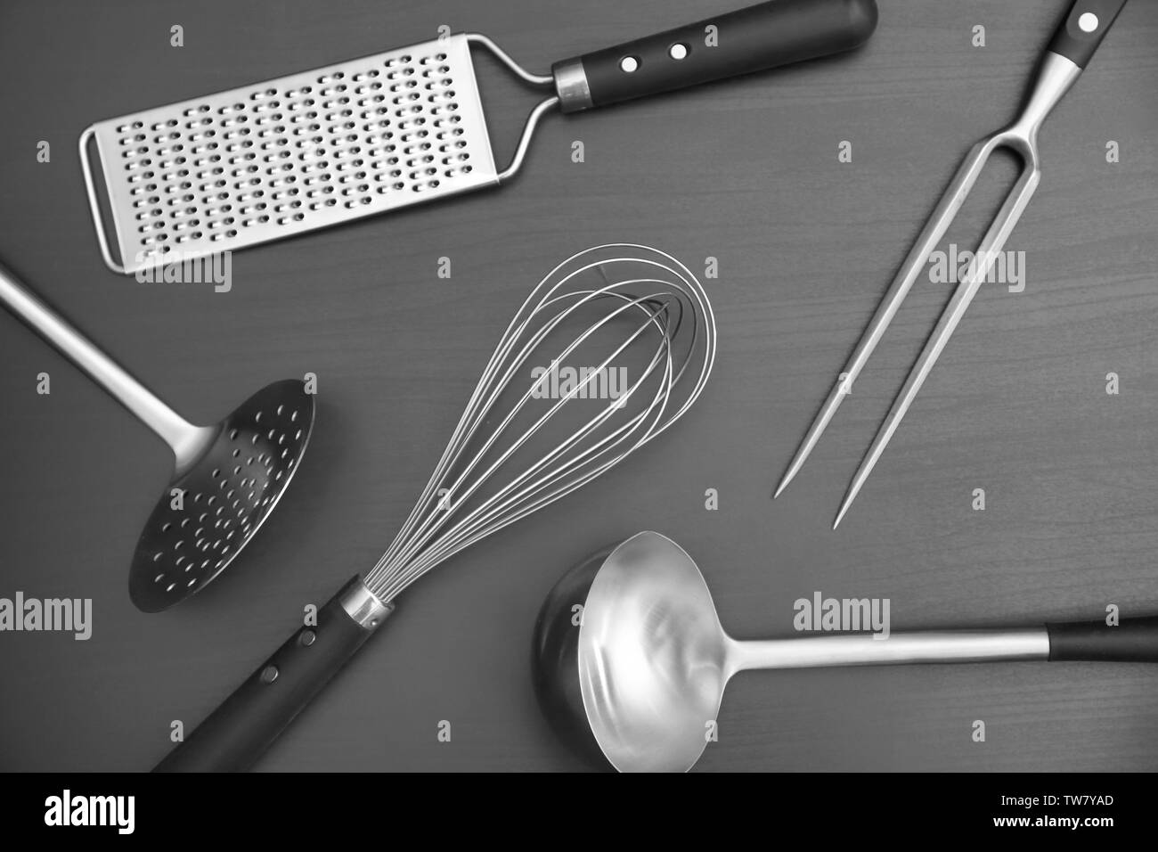 Different kitchen utensils on grey background Stock Photo - Alamy