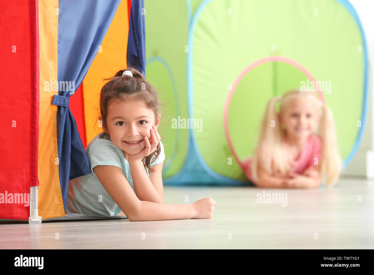 Cute little girls playing in kindergarten Stock Photo - Alamy