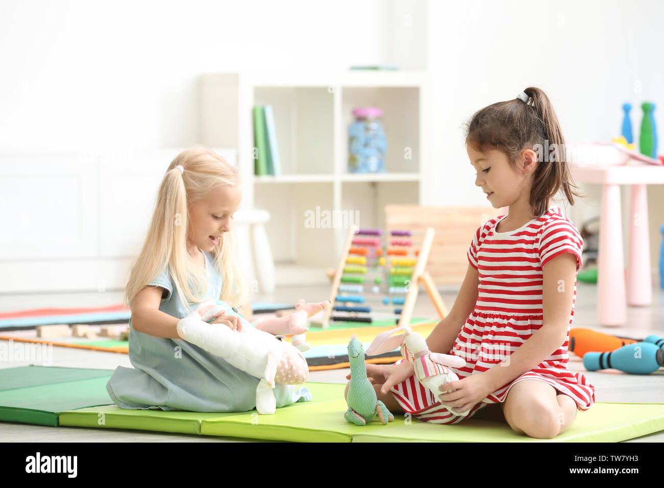 Cute little girls playing with toys in kindergarten Stock Photo - Alamy