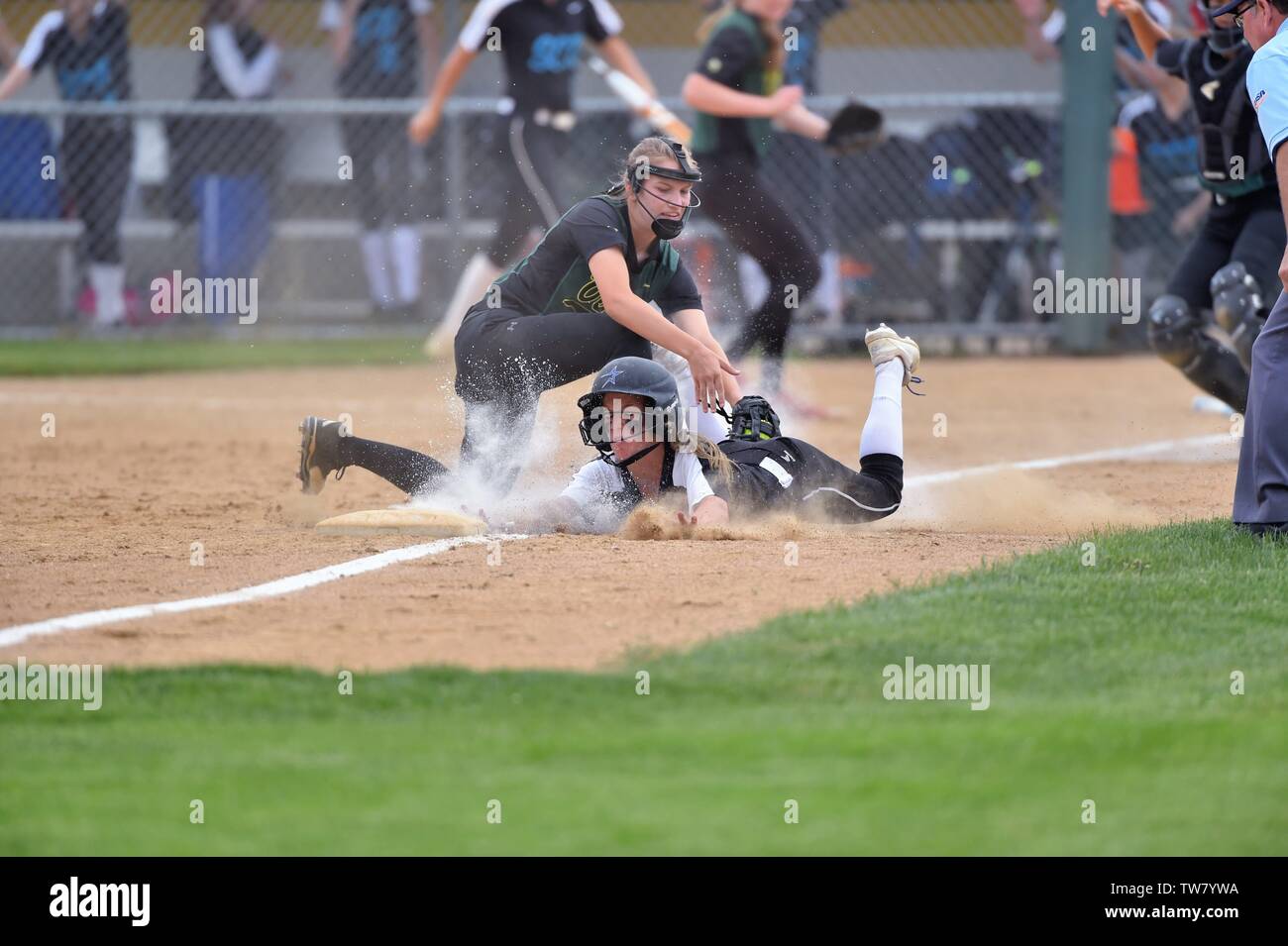 After progressing about two-thirds of the way to the plate on a teammate's ground ball, a runner was forced back to third base. USA. Stock Photo