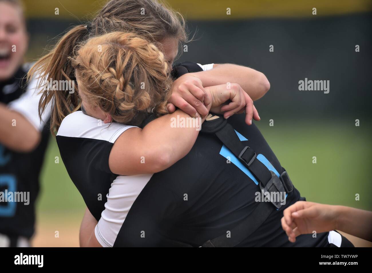Battery mates embrace immediately after the final out of their team's sectional championship win. USA. Stock Photo