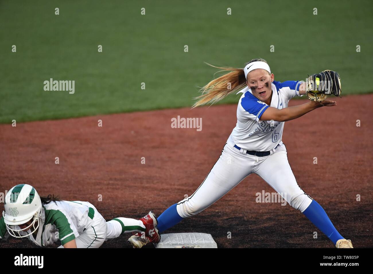 Shortstop taking a throw in an effort to catch an opposing runner. USA overrunning second base. USA. Stock Photo