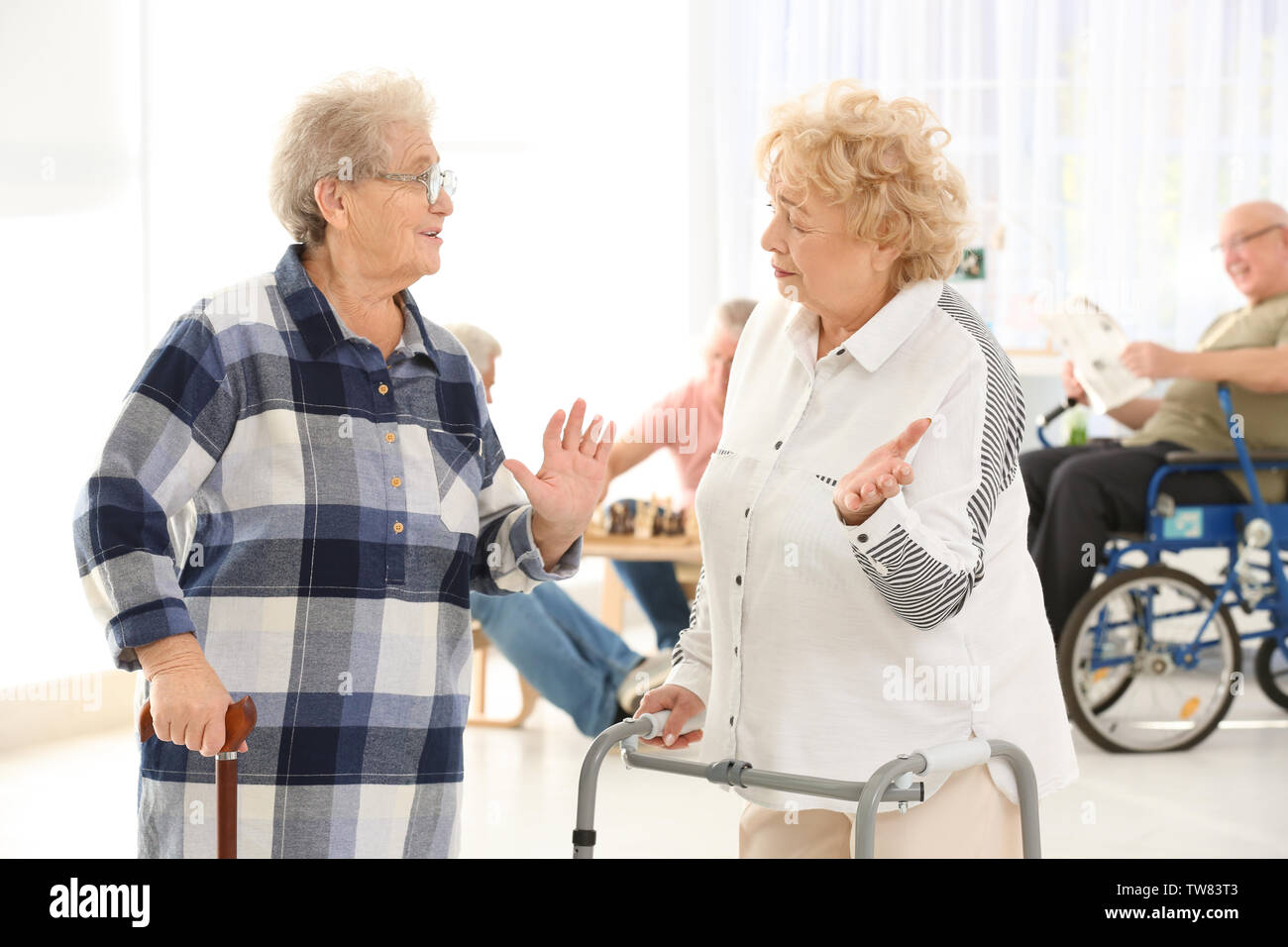 Senior women with walkers and cane talking at care home Stock Photo Alamy