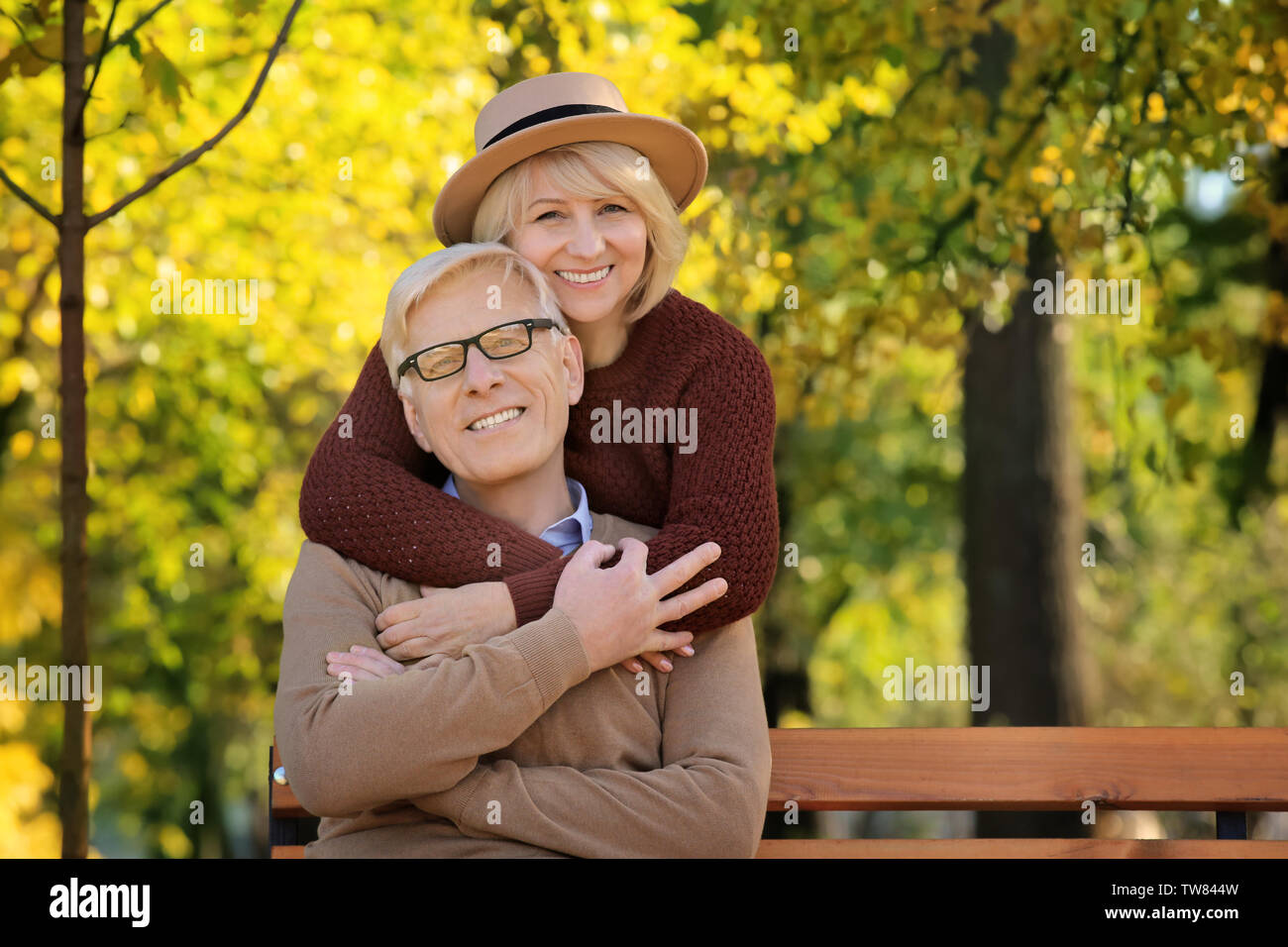 Cute elderly couple in autumn park Stock Photo - Alamy
