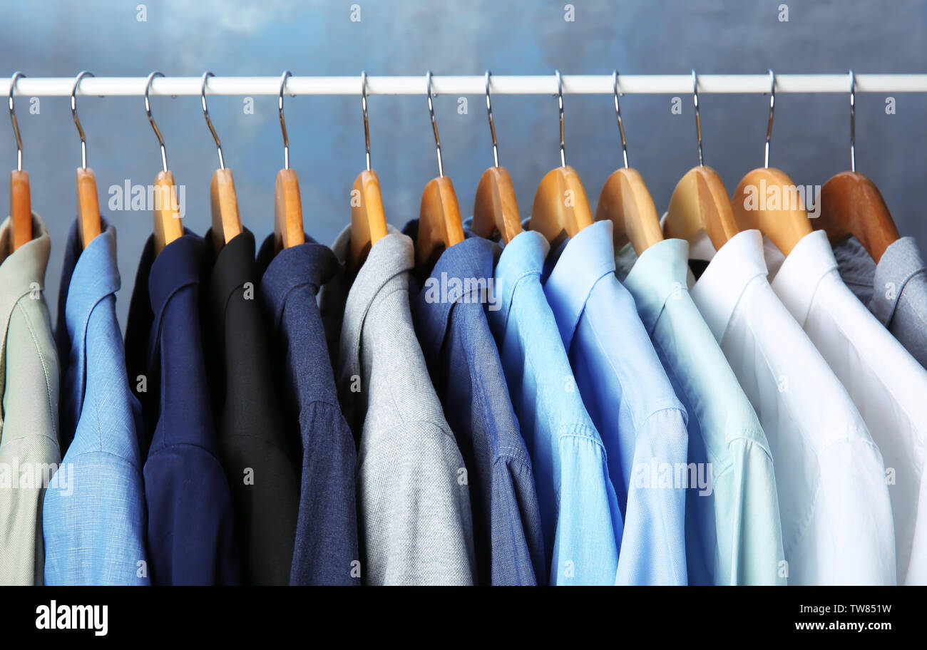 https://c8.alamy.com/comp/TW851W/male-jackets-and-shirts-hanging-on-clothing-rail-indoors-TW851W.jpg