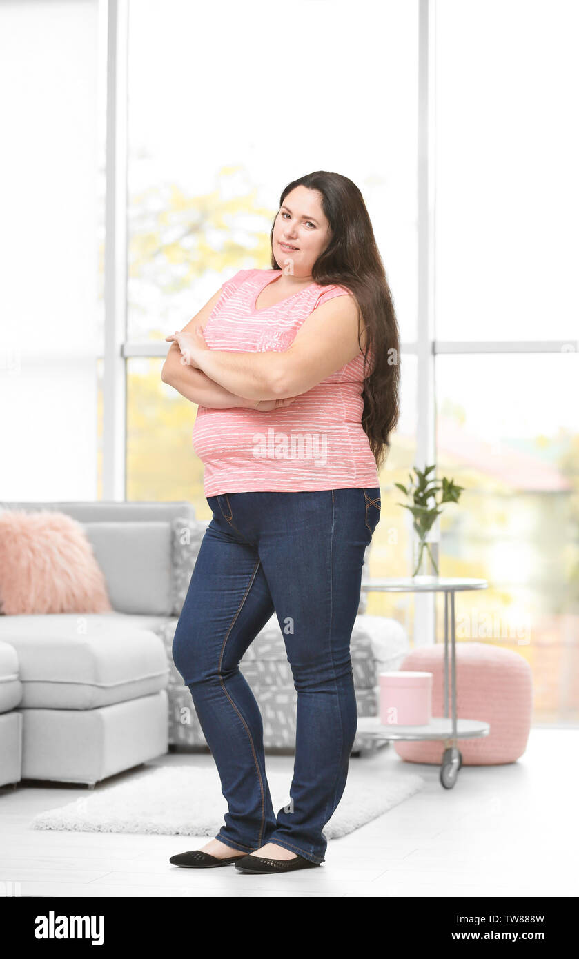 Overweight young woman posing at home Stock Photo Alamy