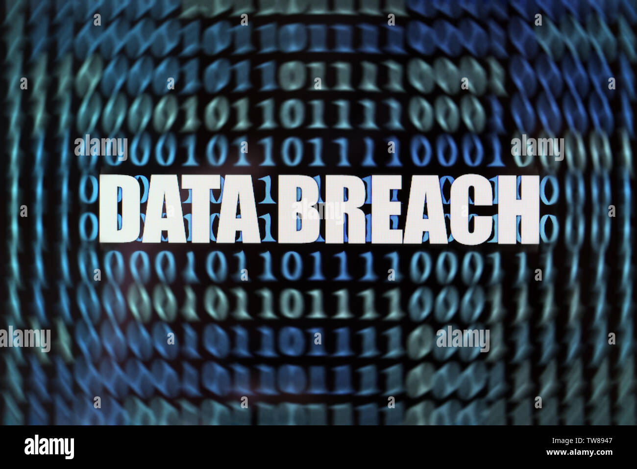 Words "Data breach" with binary code on screen Stock Photo