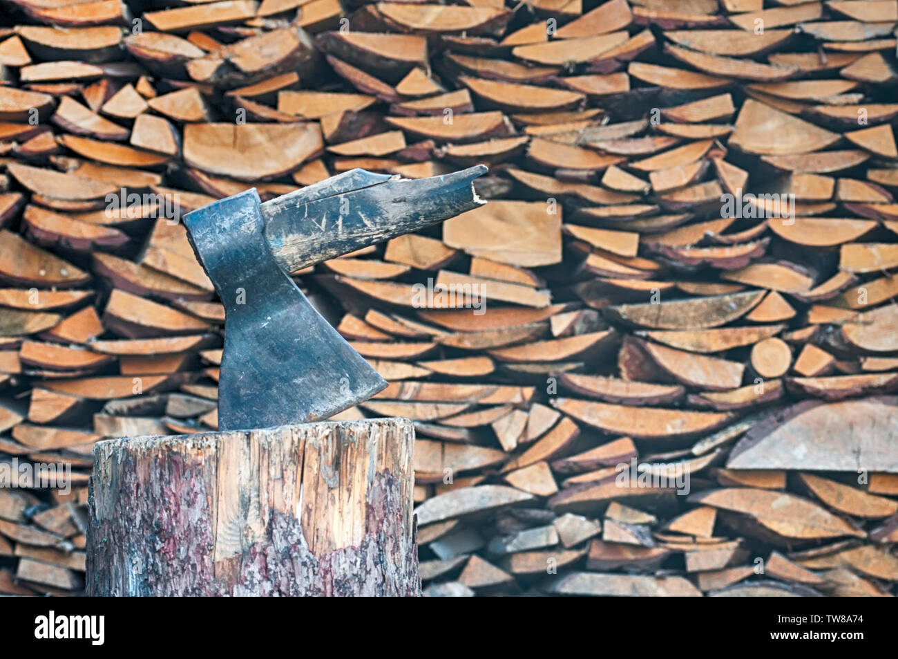 broken axe against the wall of firewood Stock Photo Alamy