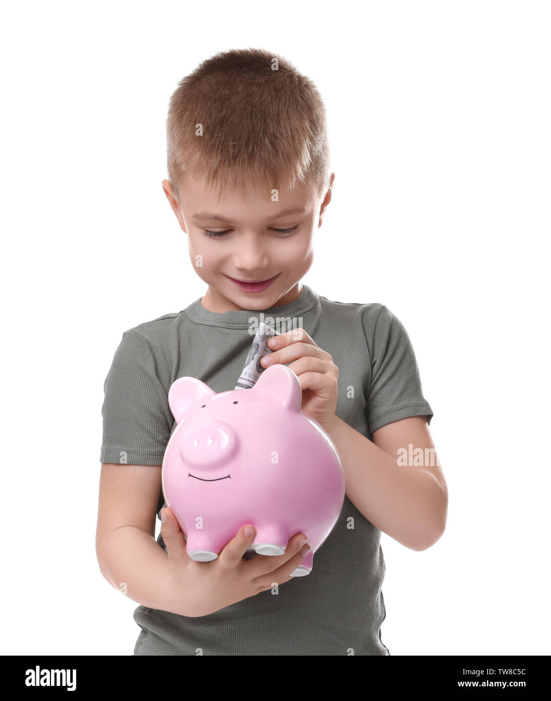 Cute little boy putting money into piggy bank on white background Stock ...