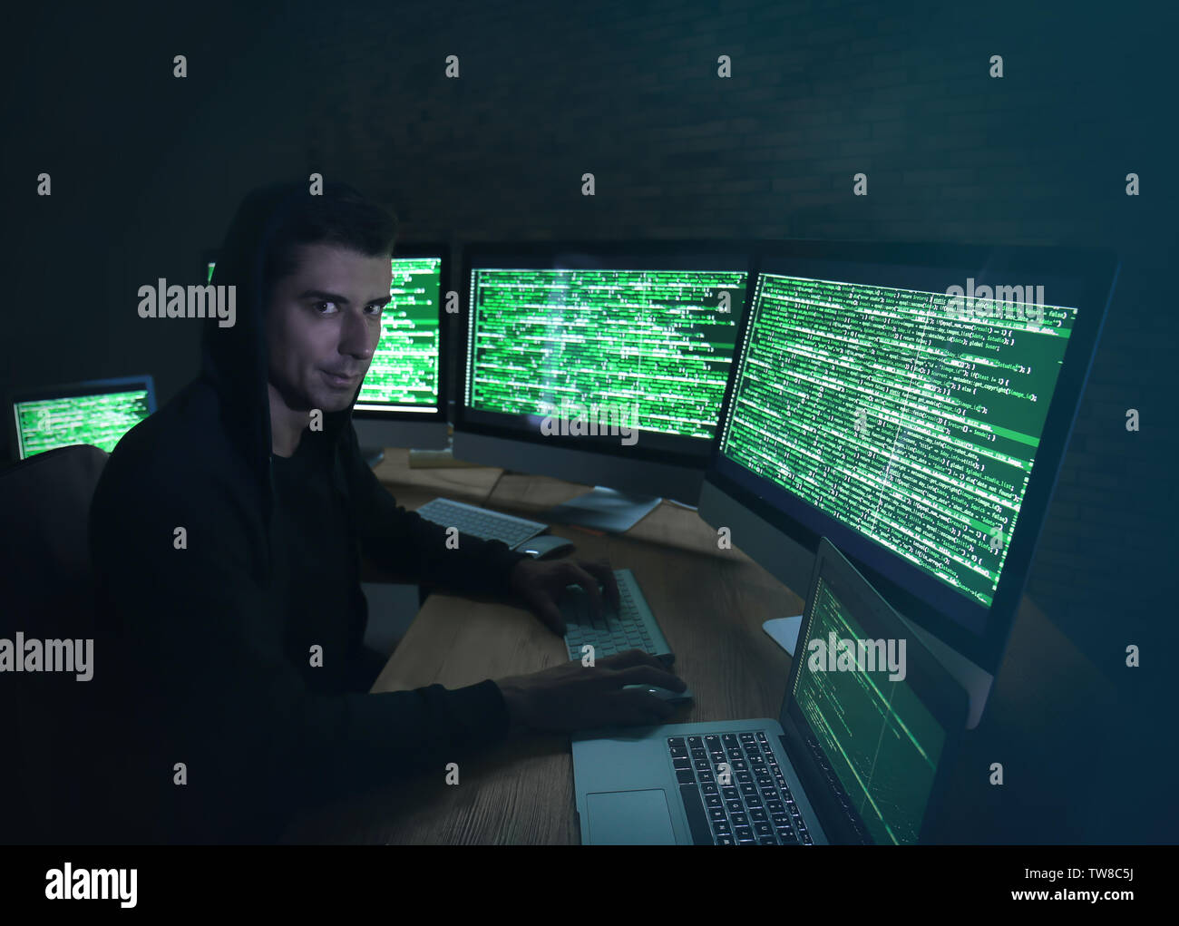 Hacker using computer in dark room. Threat of cyber attack Stock Photo ...