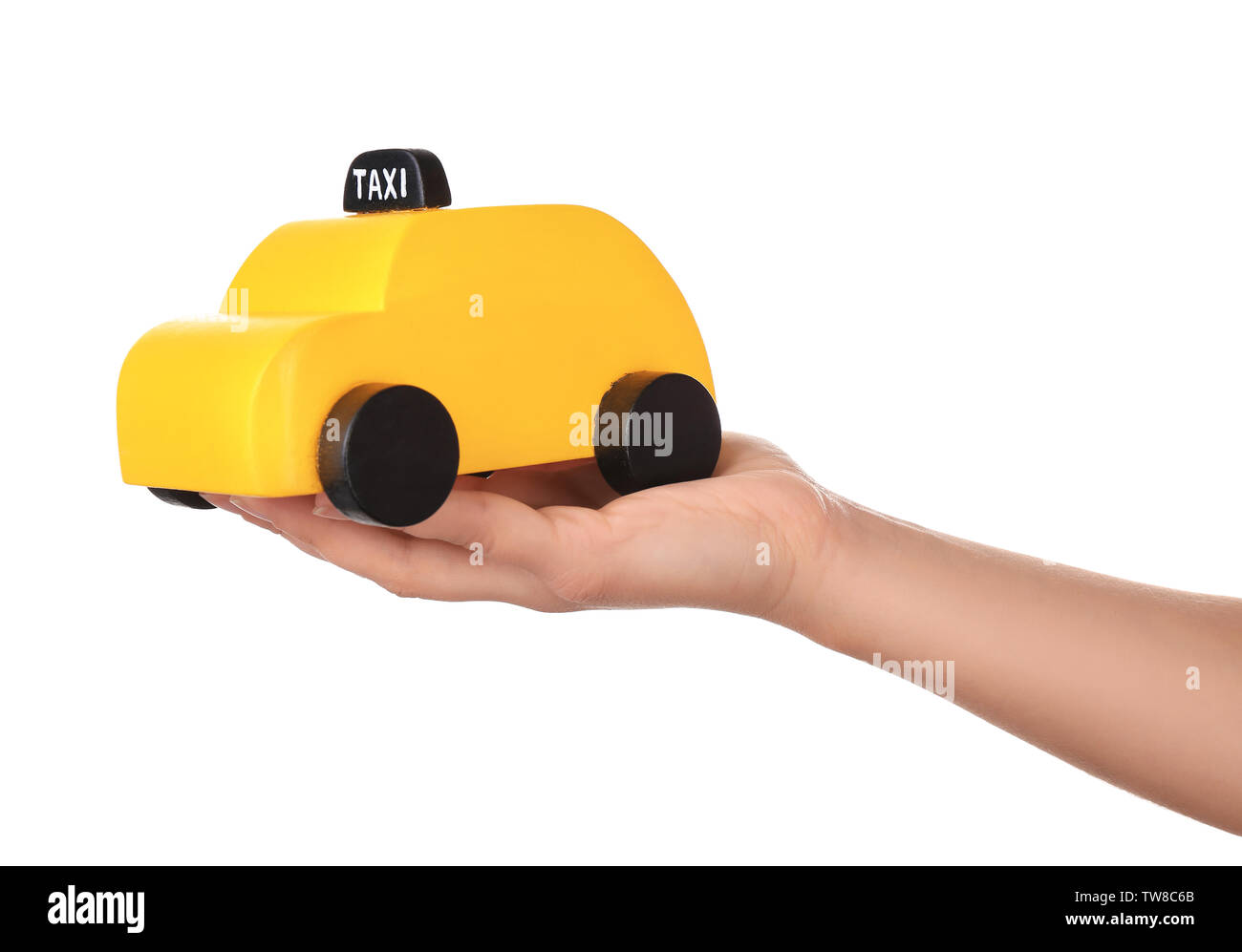 Woman holding yellow toy taxi cab on white background Stock Photo