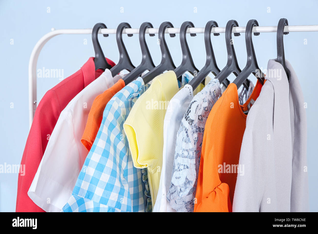 Rack of clean clothes hanging on hangers at dry-cleaning Stock Photo - Alamy