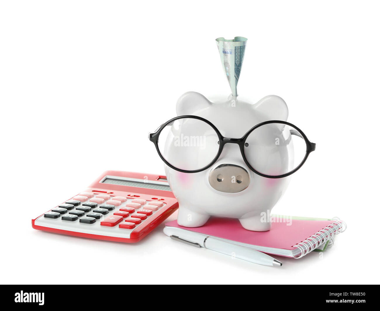 Piggy bank with banknote, glasses and stationery on white background ...