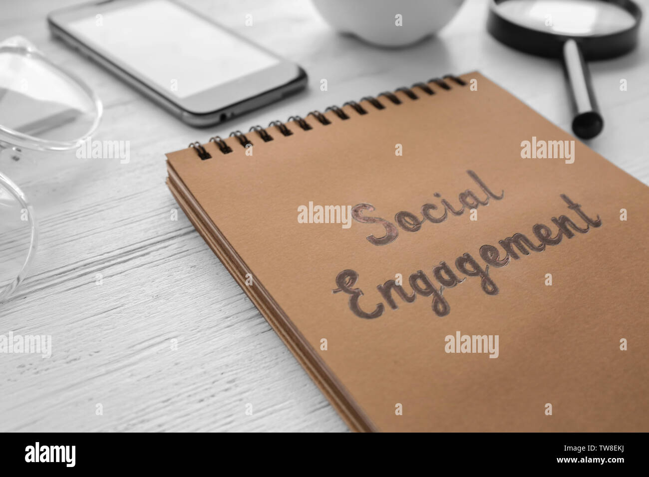 Notepad with text SOCIAL ENGAGEMENT on office table Stock Photo
