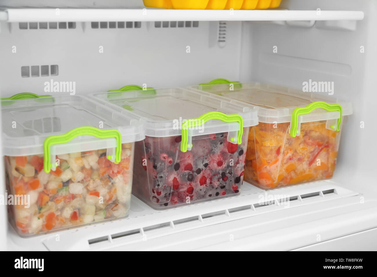 https://c8.alamy.com/comp/TW8FKW/containers-with-frozen-berries-and-vegetables-in-freezer-closeup-TW8FKW.jpg