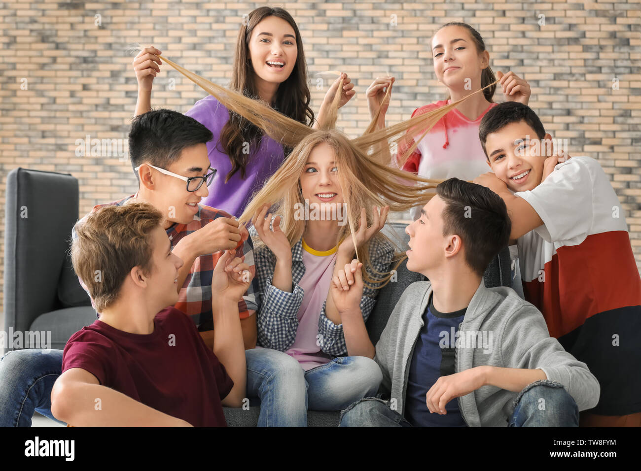 Group of cool teenagers having fun indoors Stock Photo - Alamy