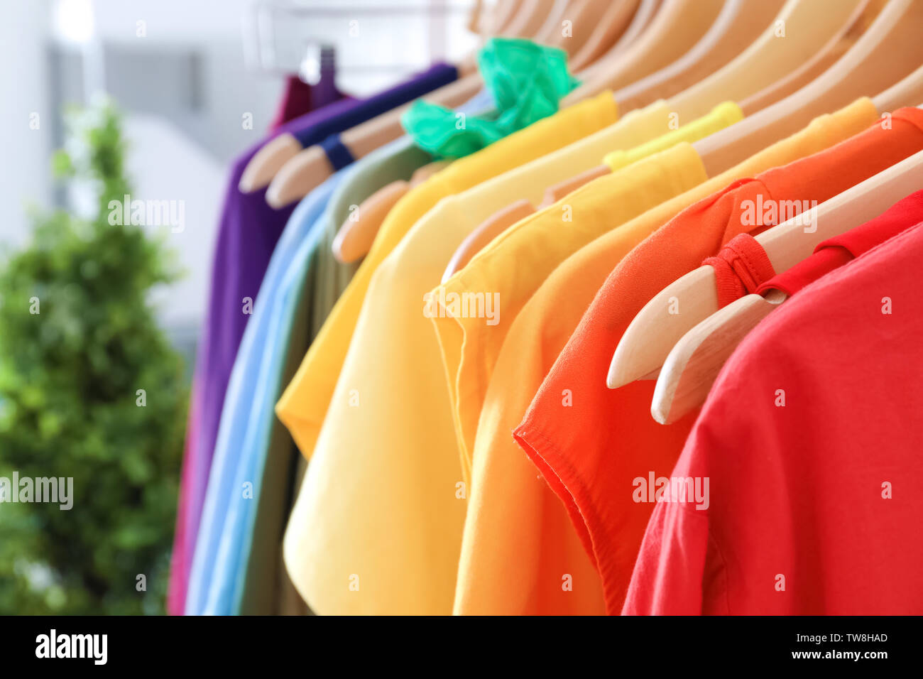 Rack with rainbow clothes, close up Stock Photo - Alamy
