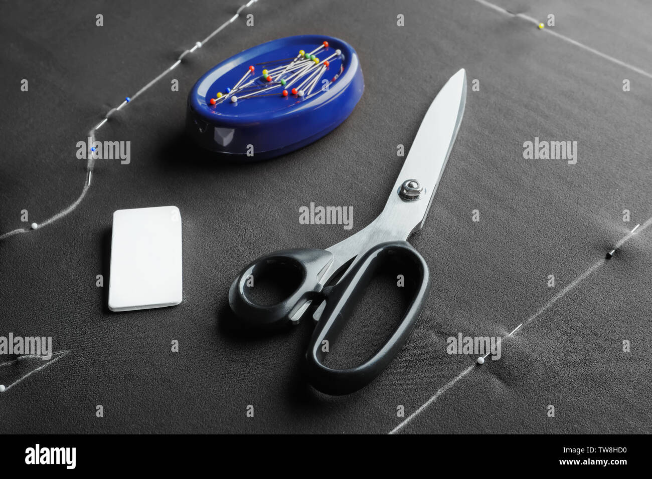 Tailoring scissors, chalk and pins on fabric Stock Photo
