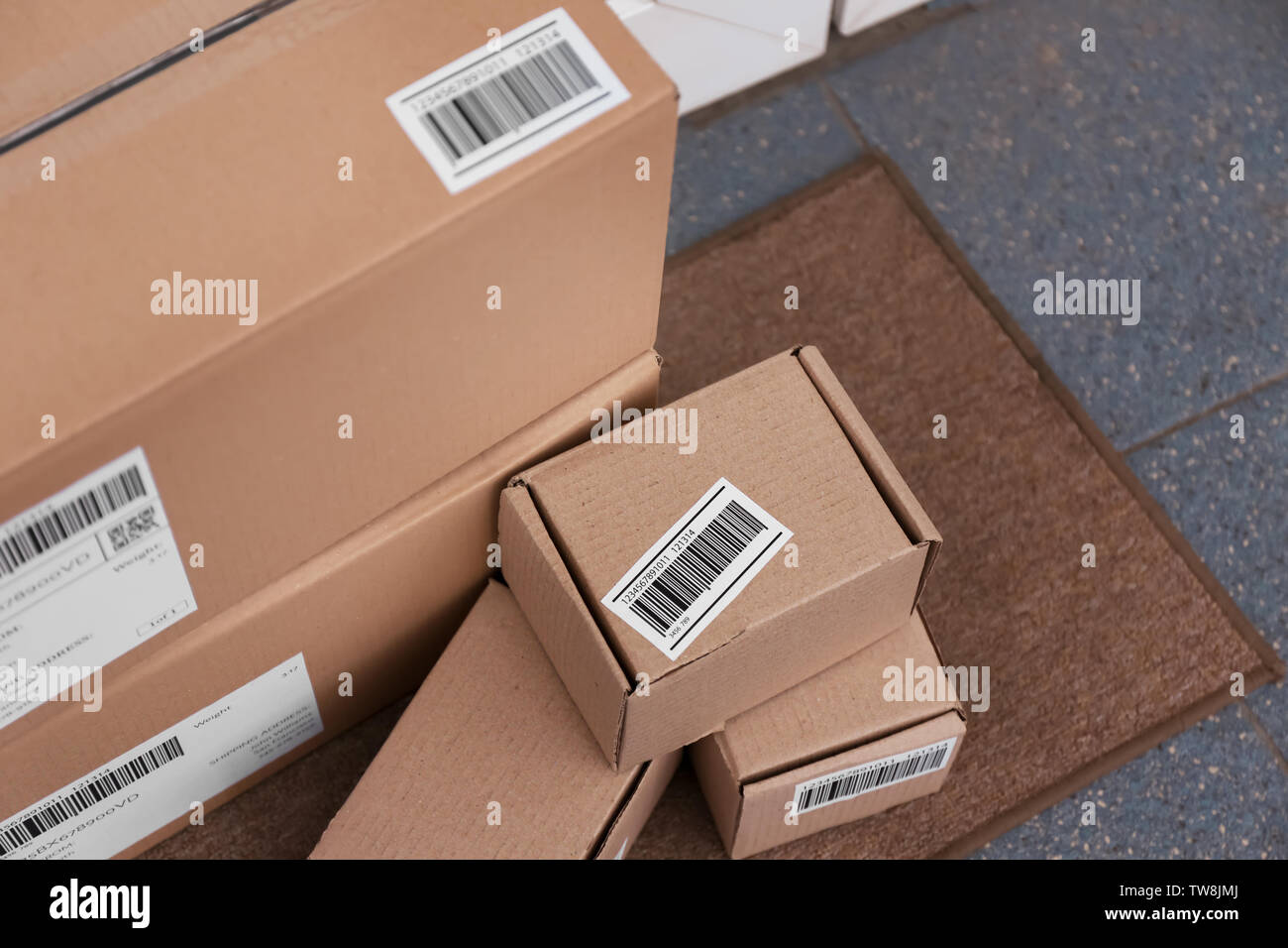 Delivered parcels on doormat, closeup Stock Photo