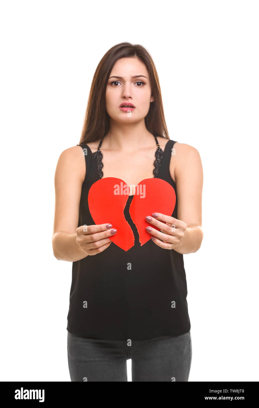 Young woman holding torn paper heart on white background Stock Photo ...