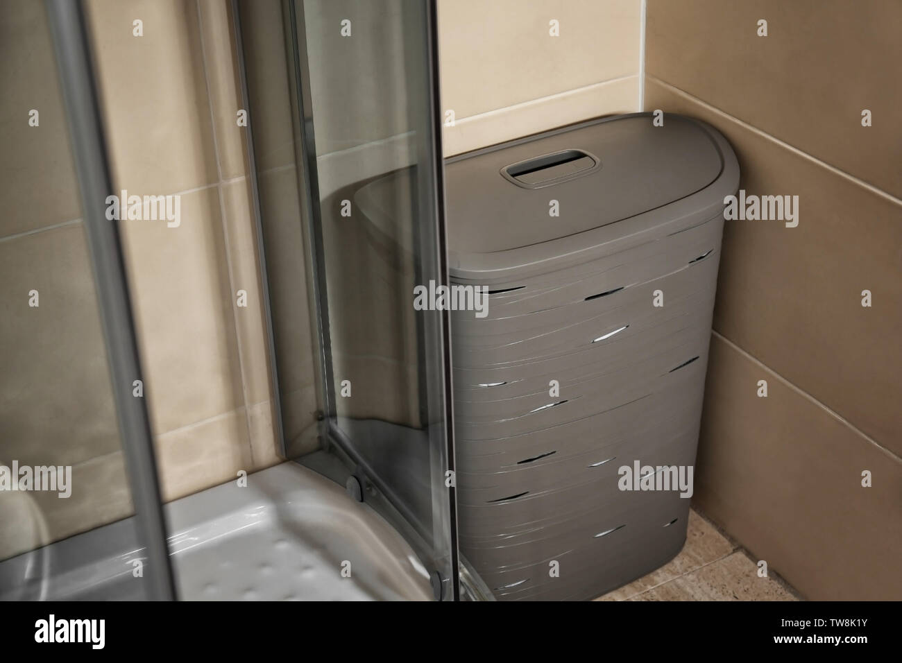 Laundry basket in bathroom Stock Photo Alamy