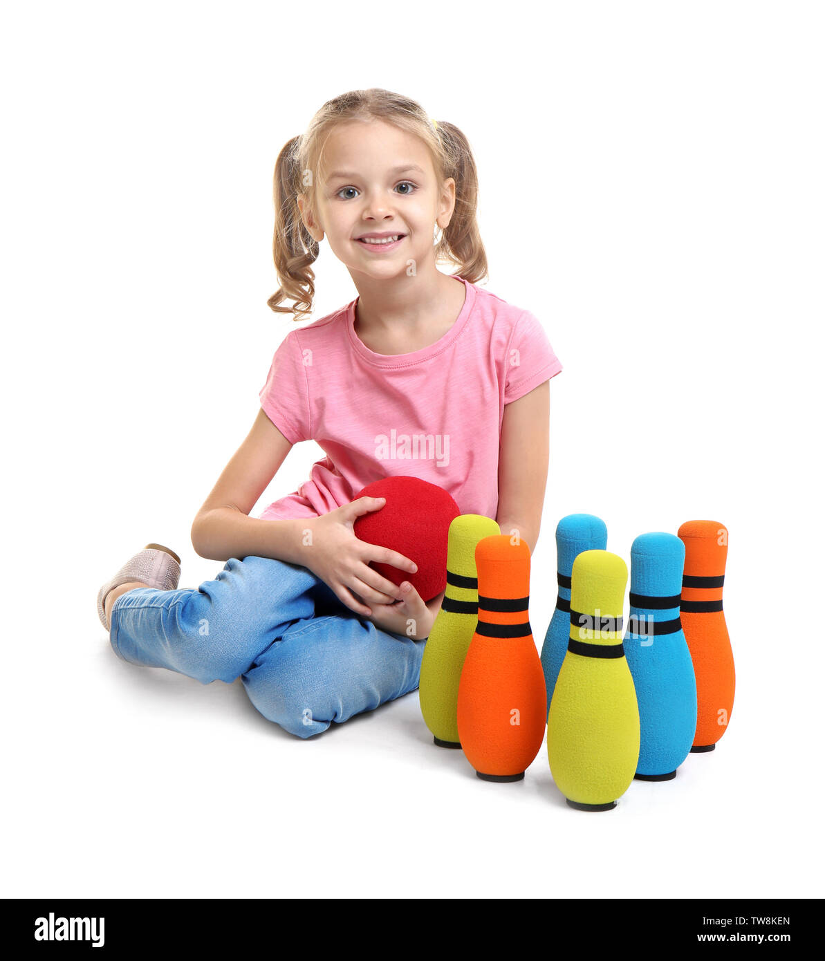 Cute little girl playing bowling on white background Stock Photo Alamy
