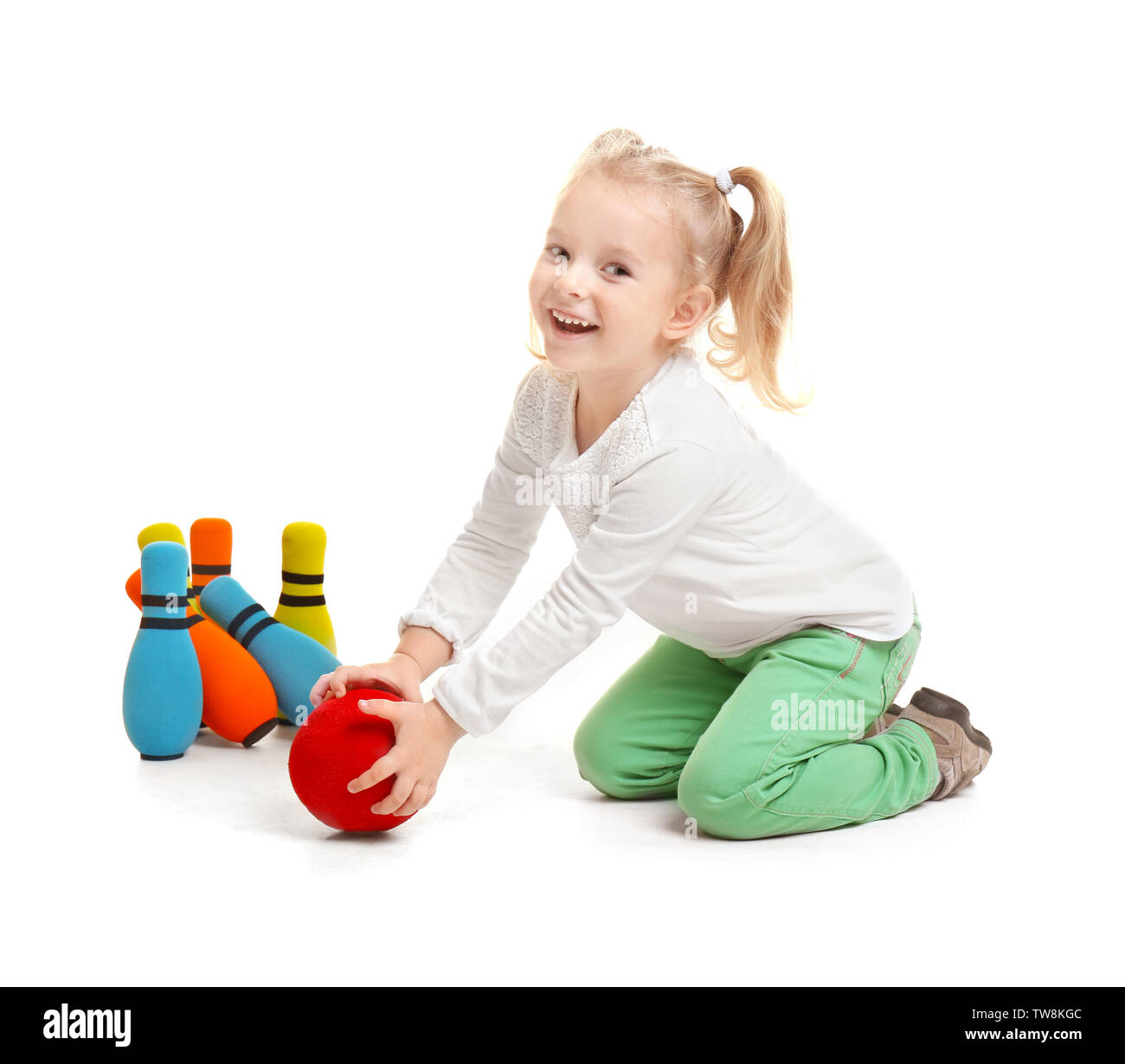 Cute little girl playing bowling on white background Stock Photo Alamy