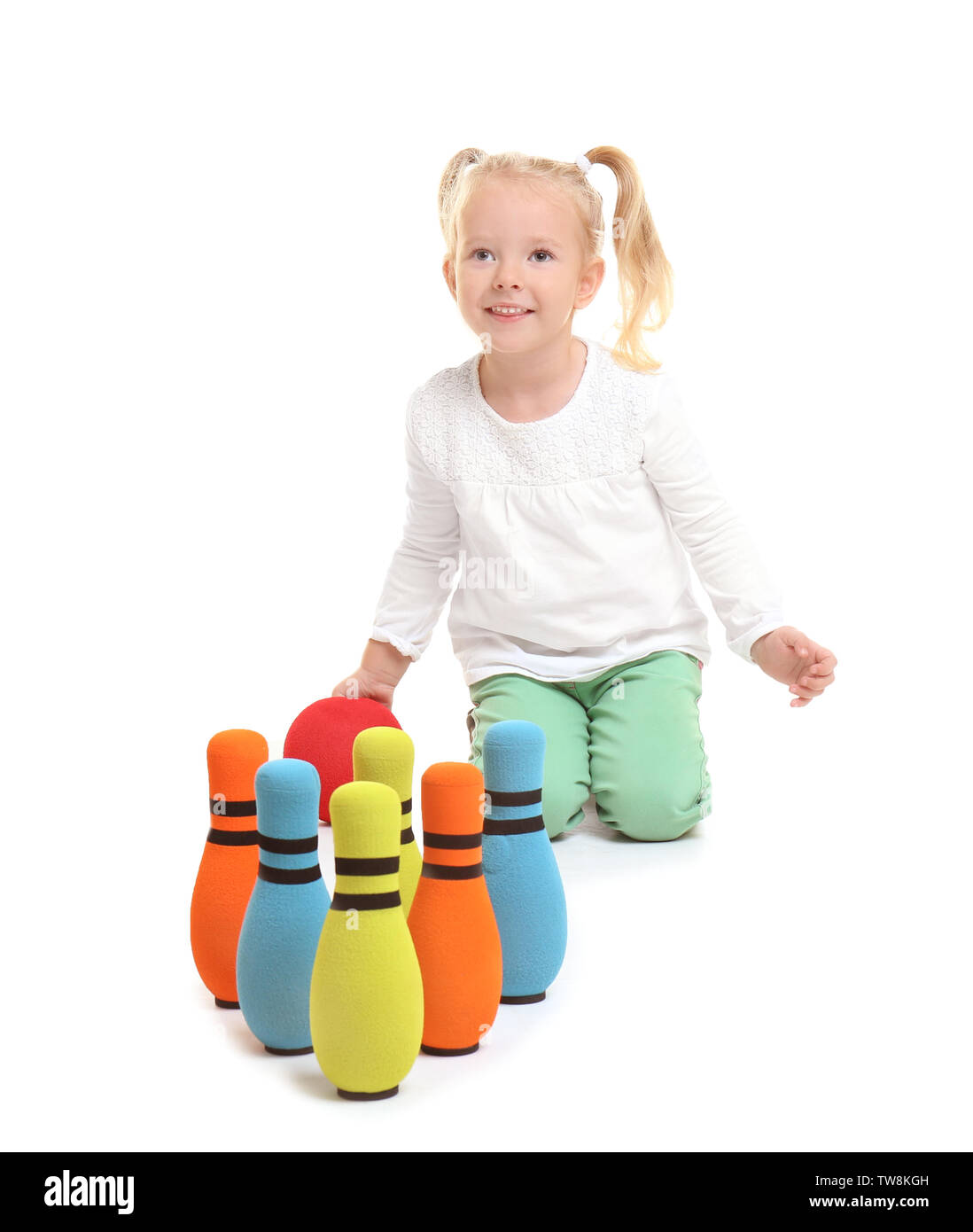 Cute little girl playing bowling on white background Stock Photo Alamy