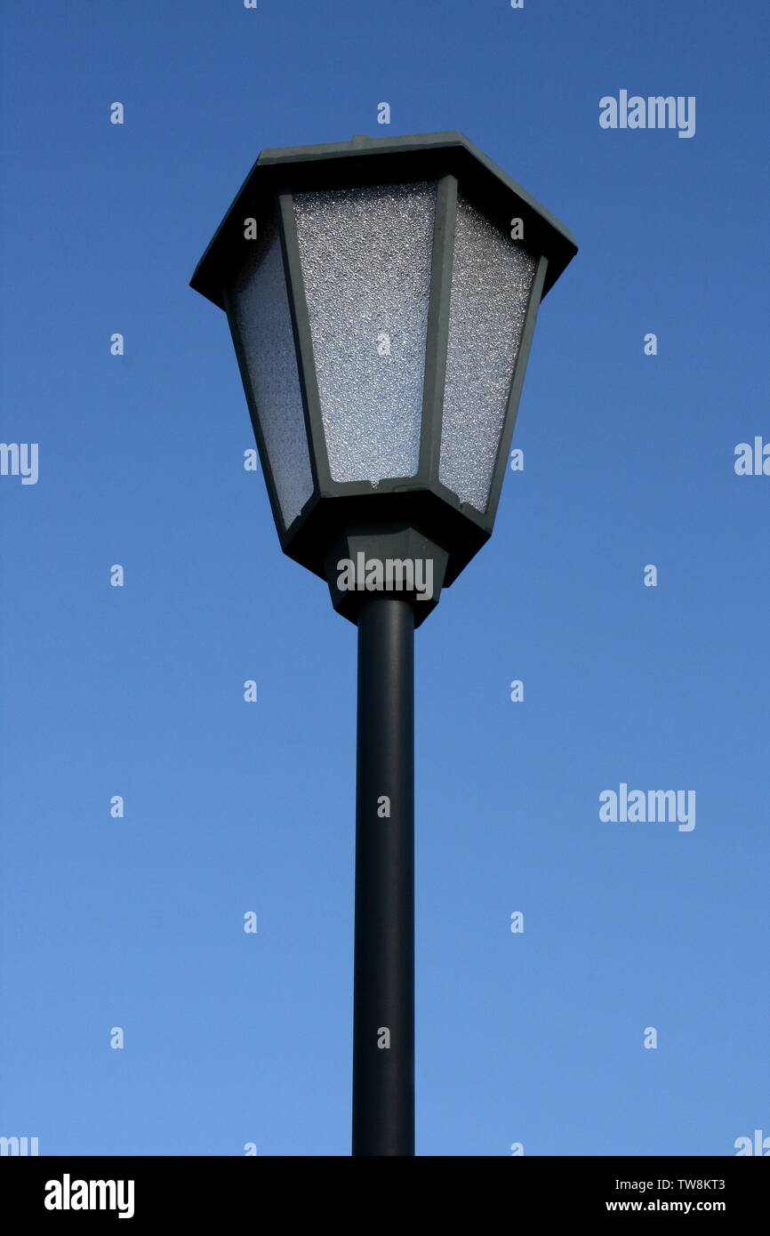 A decorated street lamp, blue sky in the background Stock Photo