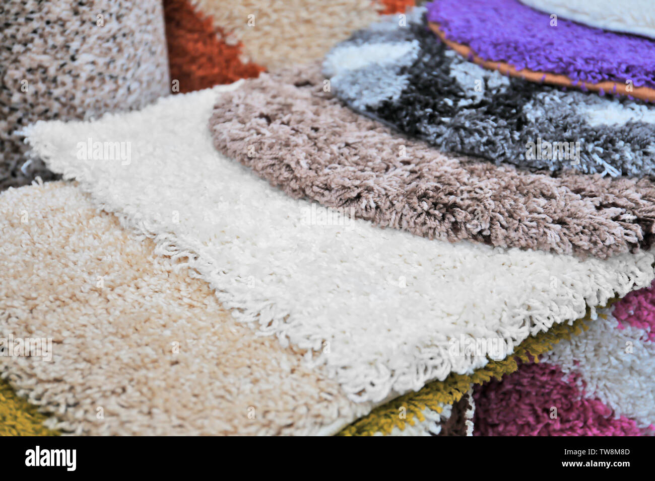Many carpets of different colors in store Stock Photo - Alamy