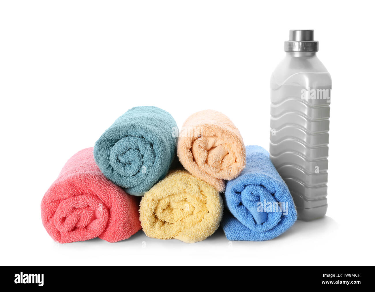 Folded towels and laundry detergent on white background Stock Photo Alamy