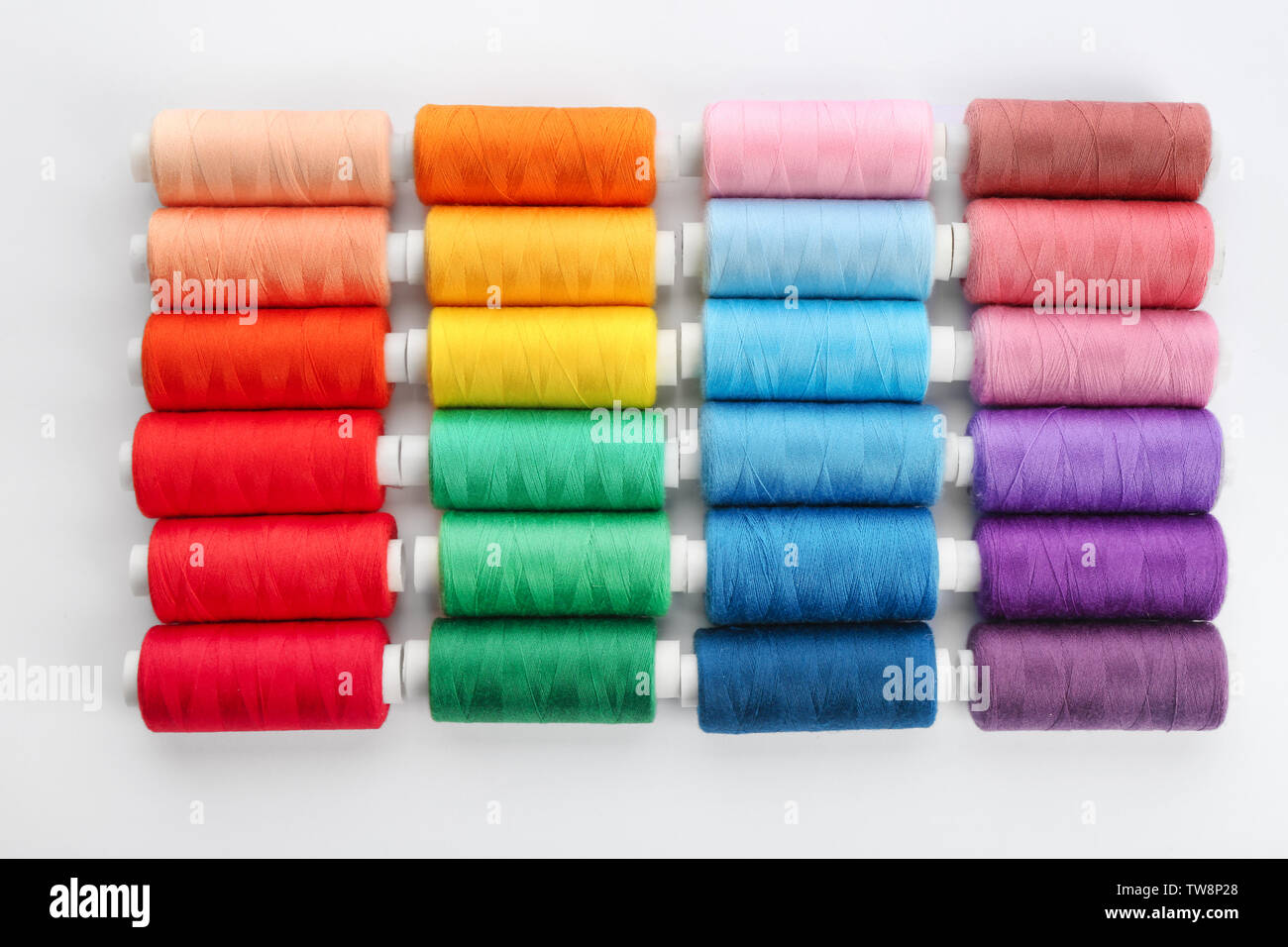 Colorful sewing threads on white background Stock Photo - Alamy