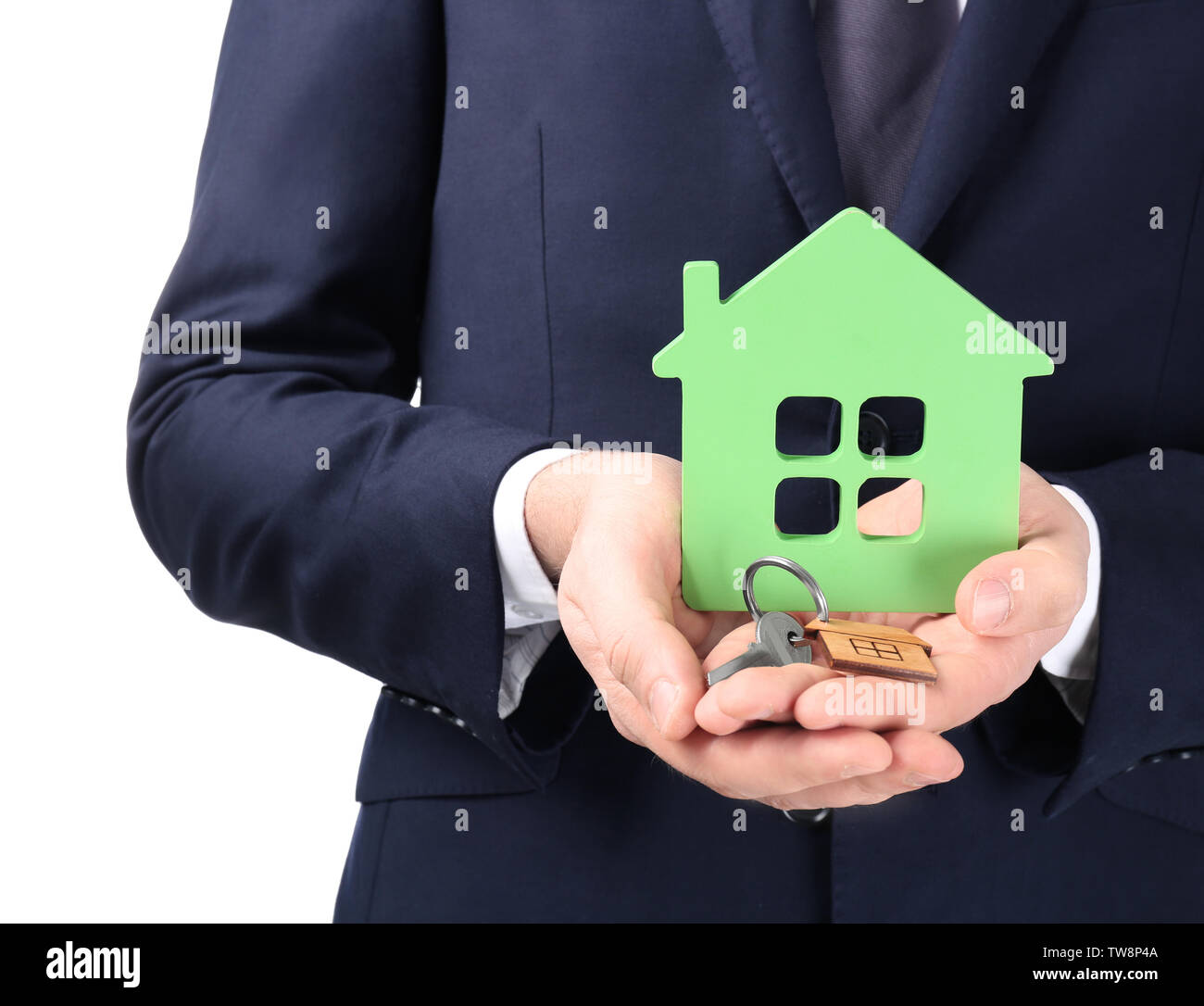 Real estate agent holding house model and key on white background Stock ...